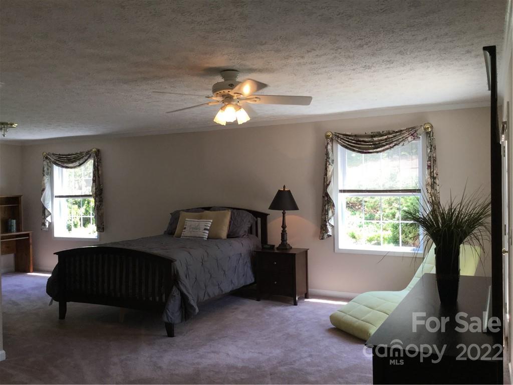 134 V S Dalton Road Rutherfordton, NC 28139 - Photo 27 of 43 a bedroom with a bed window and a fireplace