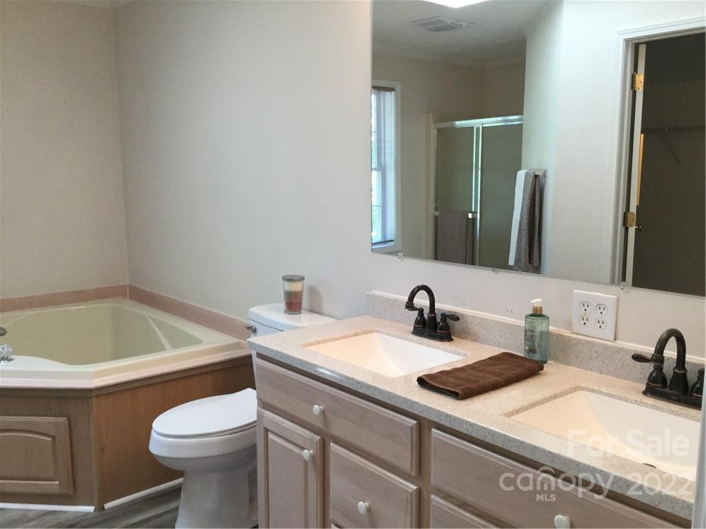 134 V S Dalton Road Rutherfordton, NC 28139 - Photo 31 of 43 a bathroom with a granite countertop sink a toilet and mirror