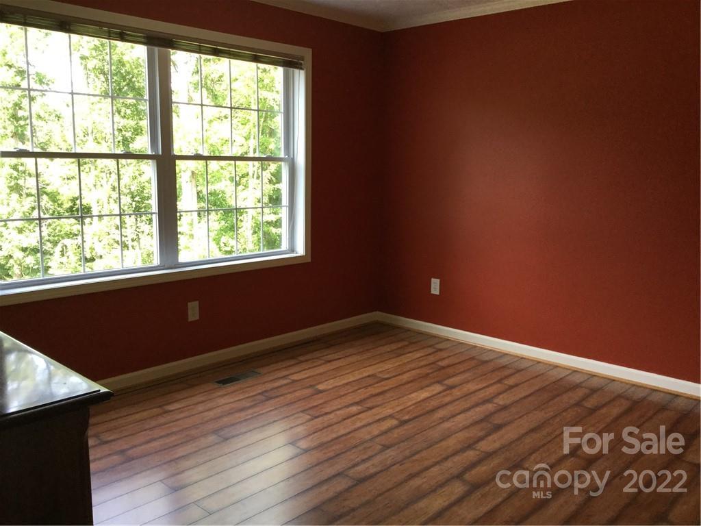 134 V S Dalton Road Rutherfordton, NC 28139 - Photo 34 of 43 an empty room with wooden floor and windows