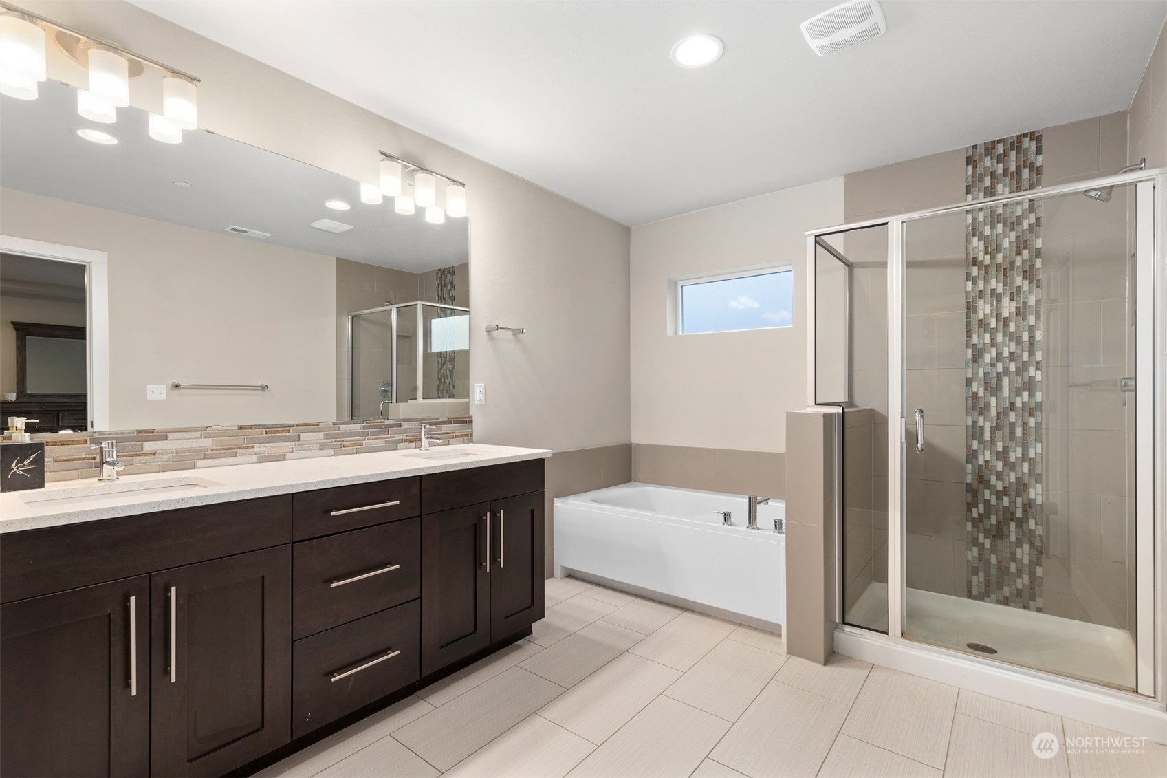 4206 223rd Place Southeast Bothell, WA 98021 - Photo 20 of 40 a bathroom with a tub a double vanity sink and mirror