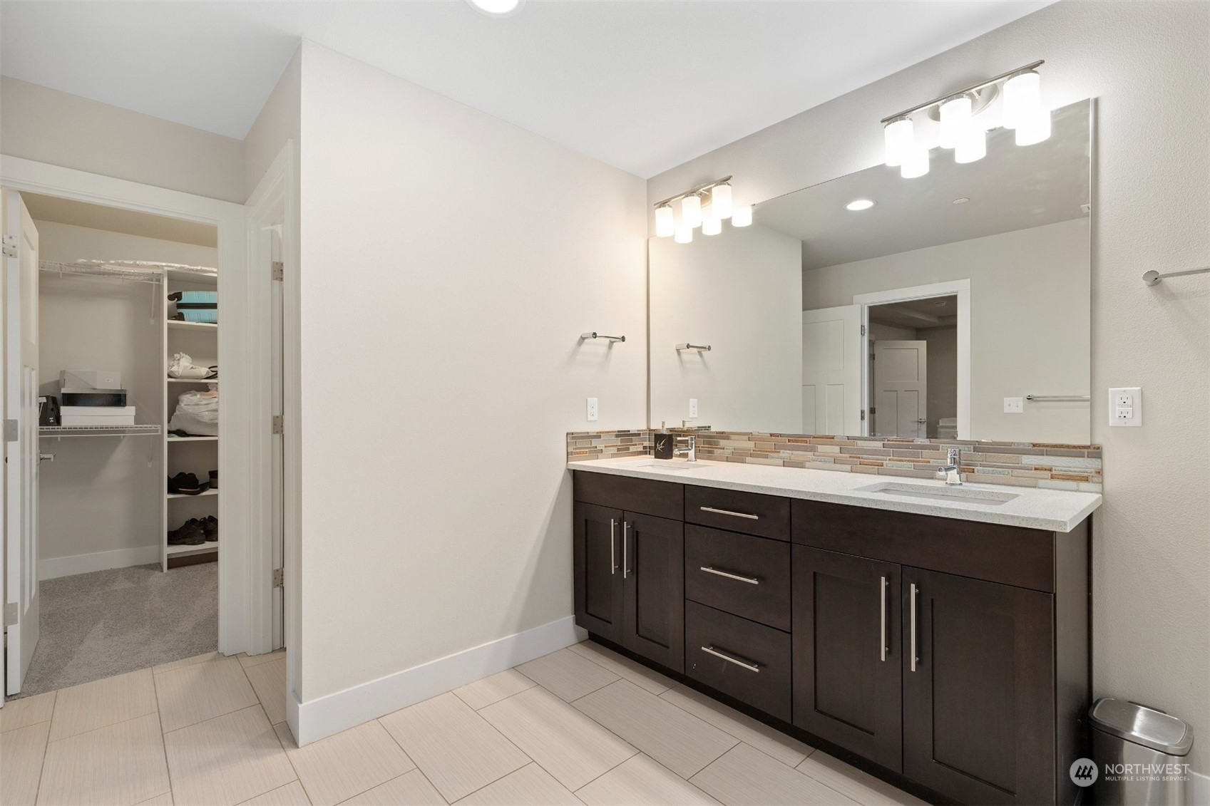 4206 223rd Place Southeast Bothell, WA 98021 - Photo 21 of 40 a bathroom with a granite countertop sink a mirror and a shower