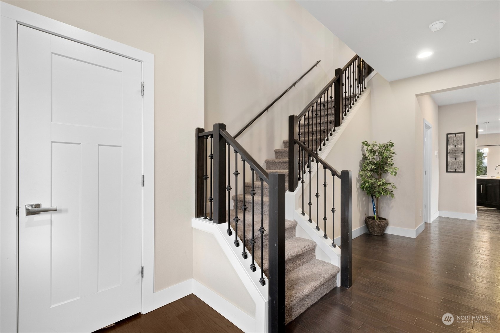 4206 223rd Place Southeast Bothell, WA 98021 - Photo 4 of 40 a view of staircase with lots of frames on wall and wooden floor