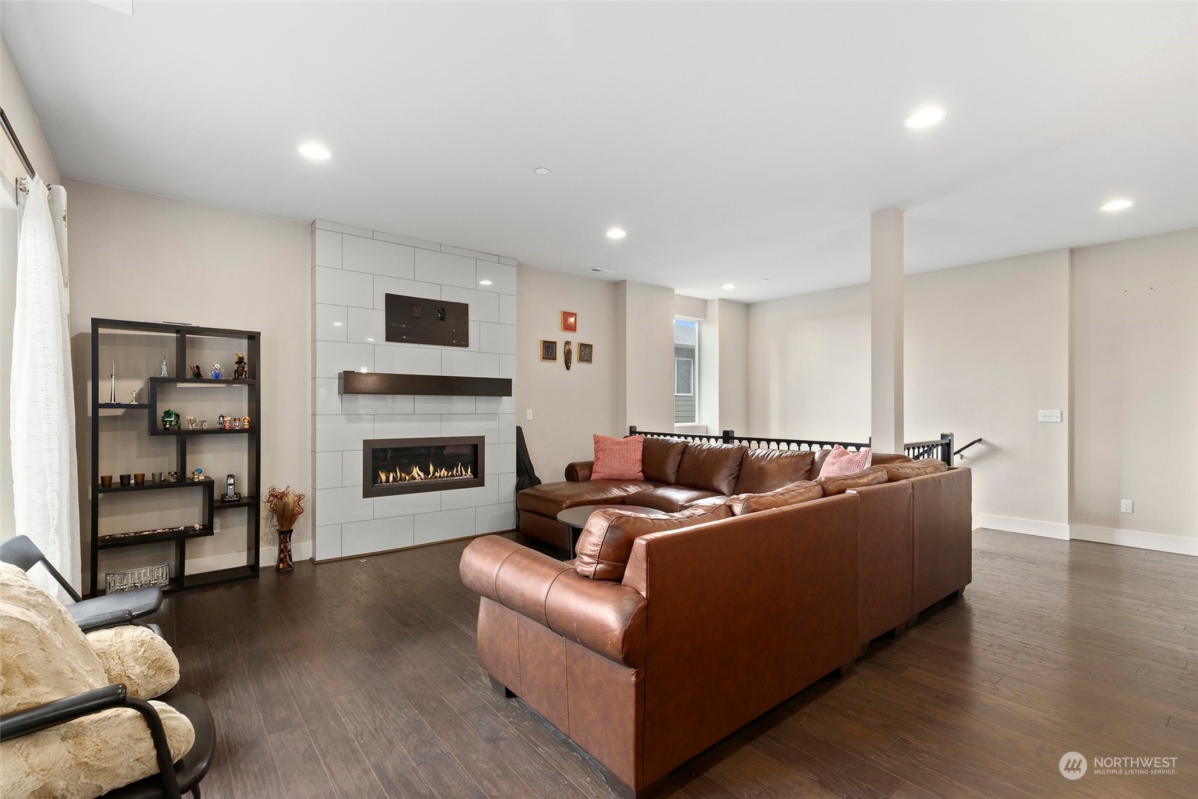 4206 223rd Place Southeast Bothell, WA 98021 - Photo 6 of 40 a living room with furniture a flat screen tv and a fireplace