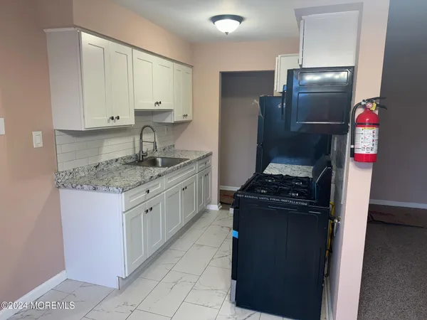 a kitchen with granite countertop stainless steel appliances and counter space