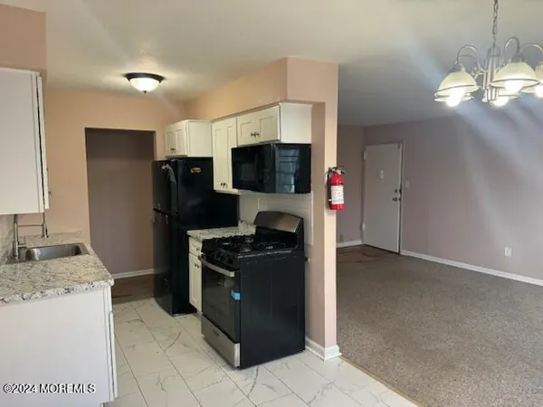 a kitchen with a refrigerator and a sink
