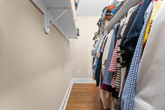 a view of walk in closet with clothes