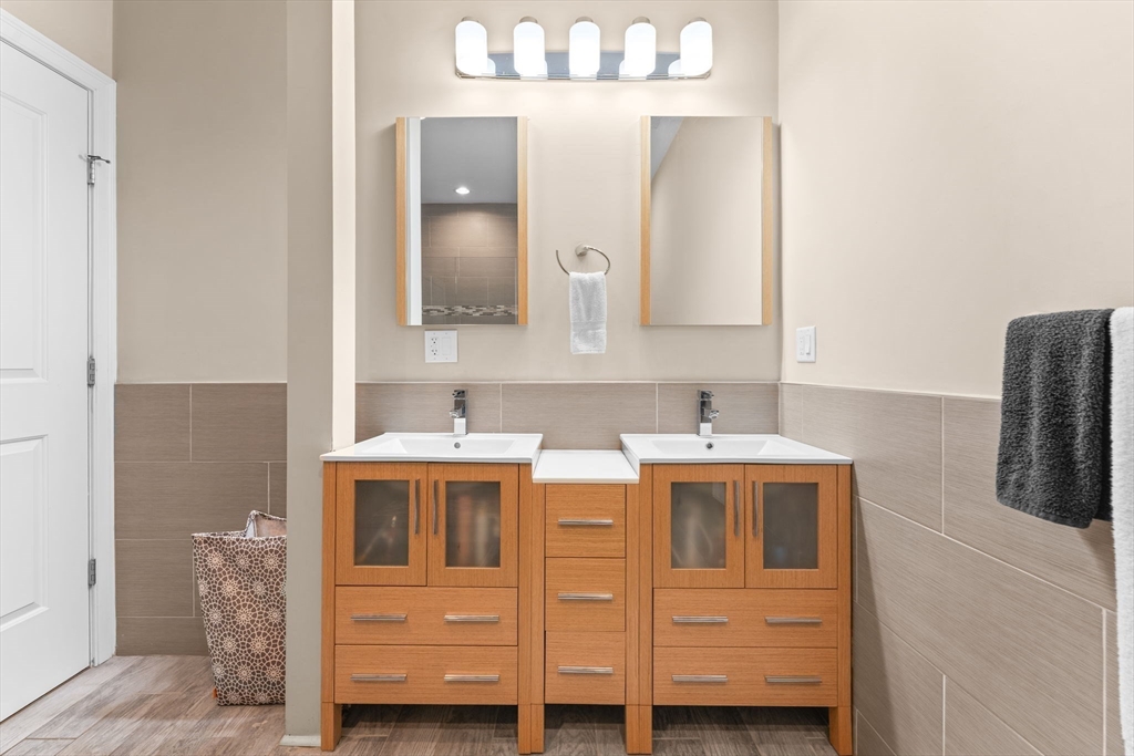 380 West Broadway, Unit 401 Boston, MA 02127 - Photo 15 of 25 a bathroom with a sink and a mirror