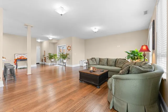 a living room with furniture and a wooden floor