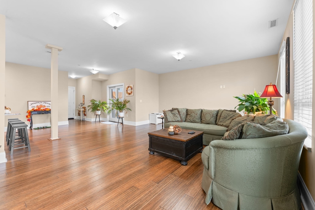 380 West Broadway, Unit 401 Boston, MA 02127 - Photo 8 of 25 a living room with furniture and a wooden floor