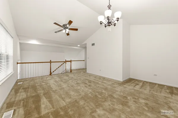 a view of a livingroom with a ceiling fan and window