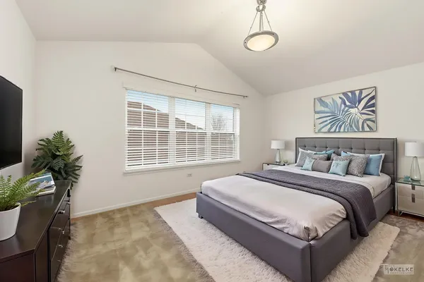 a spacious bedroom with a large bed and a window