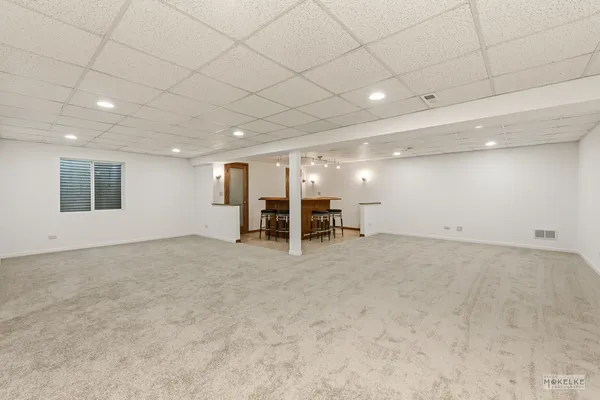 an empty room with a table and chairs