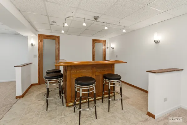 a view of a dining room with furniture and a chandelier