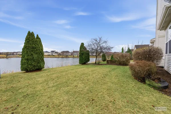 a swimming pool with outdoor seating and yard