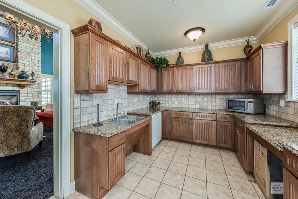 a kitchen with stainless steel appliances granite countertop a stove sink and cabinets