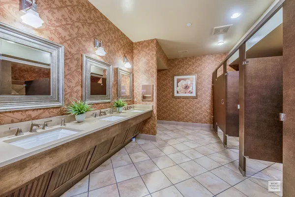 a spacious bathroom with a double vanity sink mirror and shower
