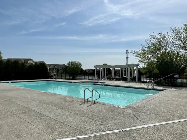 a view of a swimming pool with a yard