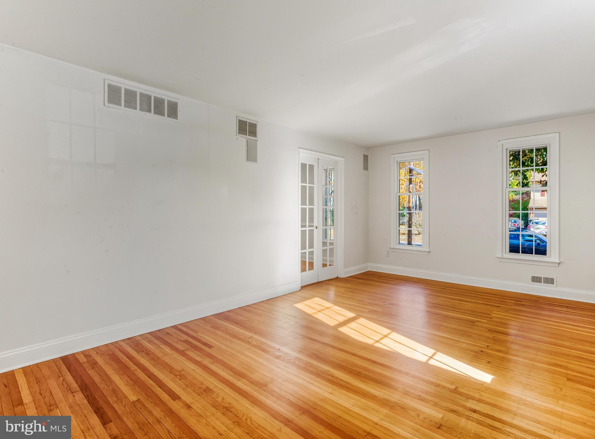 1102 Barnesdale Road West Deptford, NJ 08096 - Photo 12 of 32 a view of an empty room with window and wooden floor