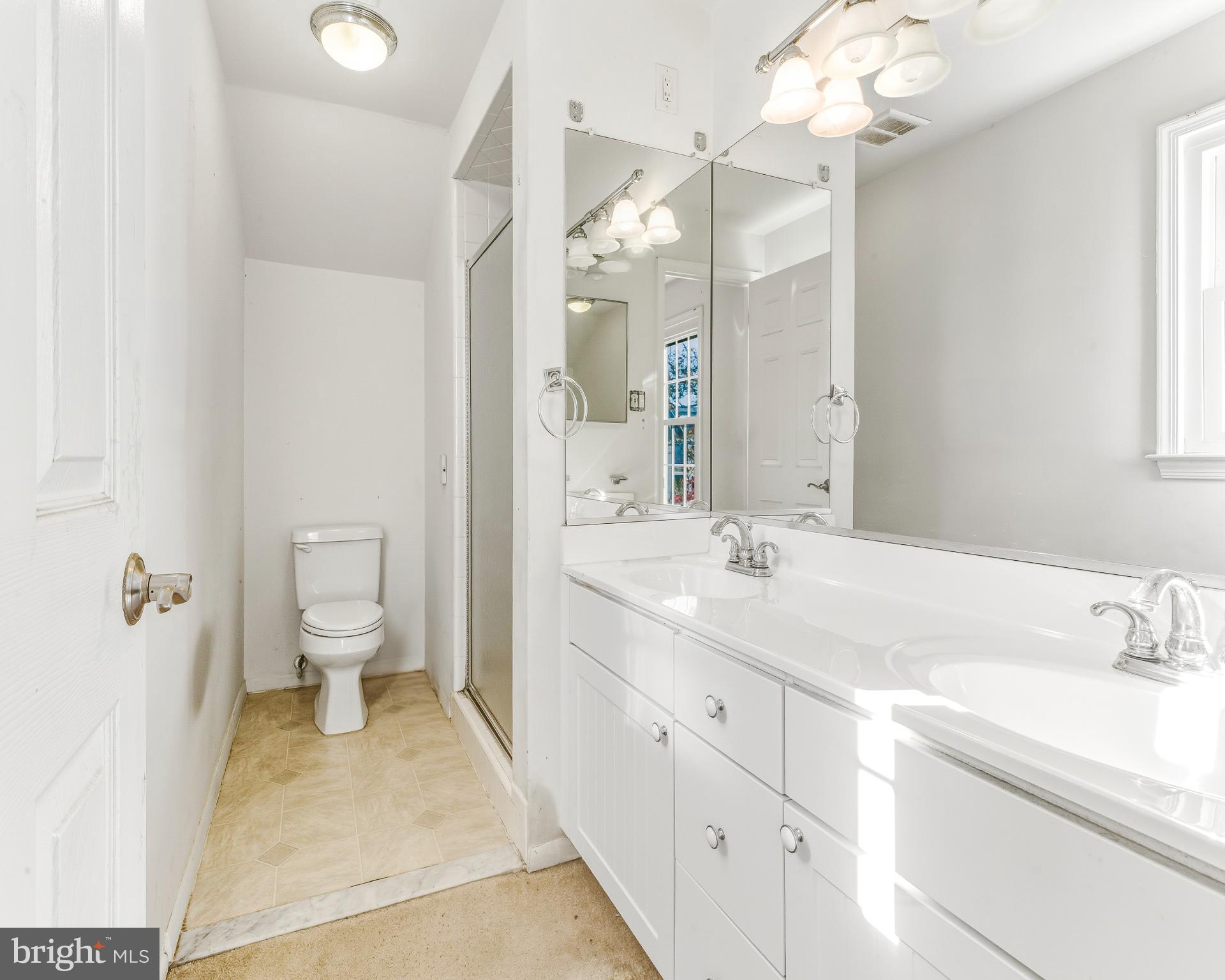 1102 Barnesdale Road West Deptford, NJ 08096 - Photo 21 of 32 a spacious bathroom with a double vanity sink mirror and toilet