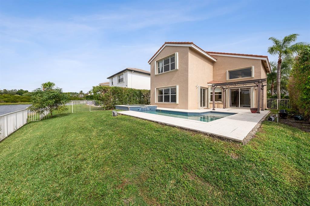 2755 Southwest 165th Avenue Miramar, FL 33027 - Photo 18 of 18 a front view of a house with a yard