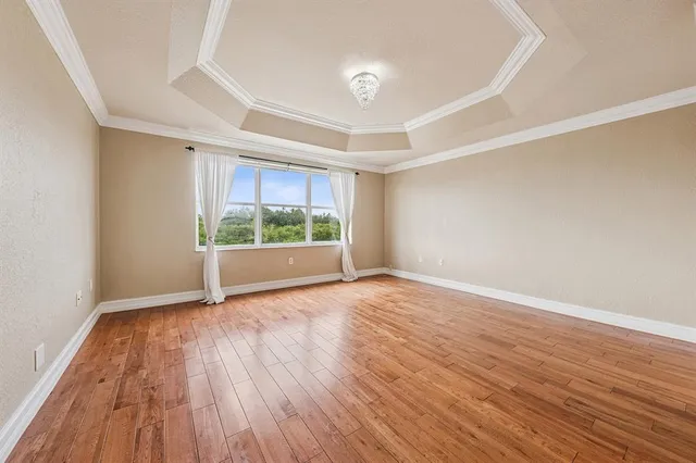 wooden floor in an empty room with a window