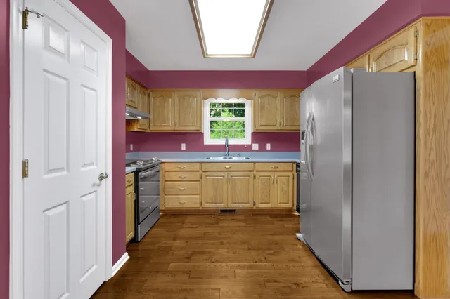 a kitchen with a refrigerator and window
