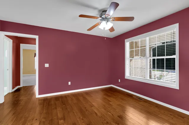 a view of a livingroom with a ceiling fan and window