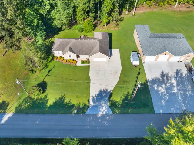 an aerial view of a house with a yard