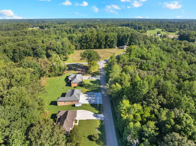 an aerial view of a house with a yard
