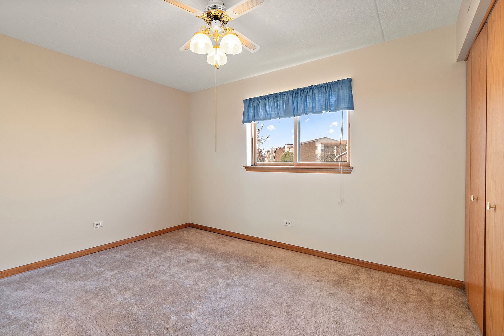 18136 Rita Road, Unit 1C Tinley Park, IL 60477 - Photo 14 of 26 an empty room with a window and a fan