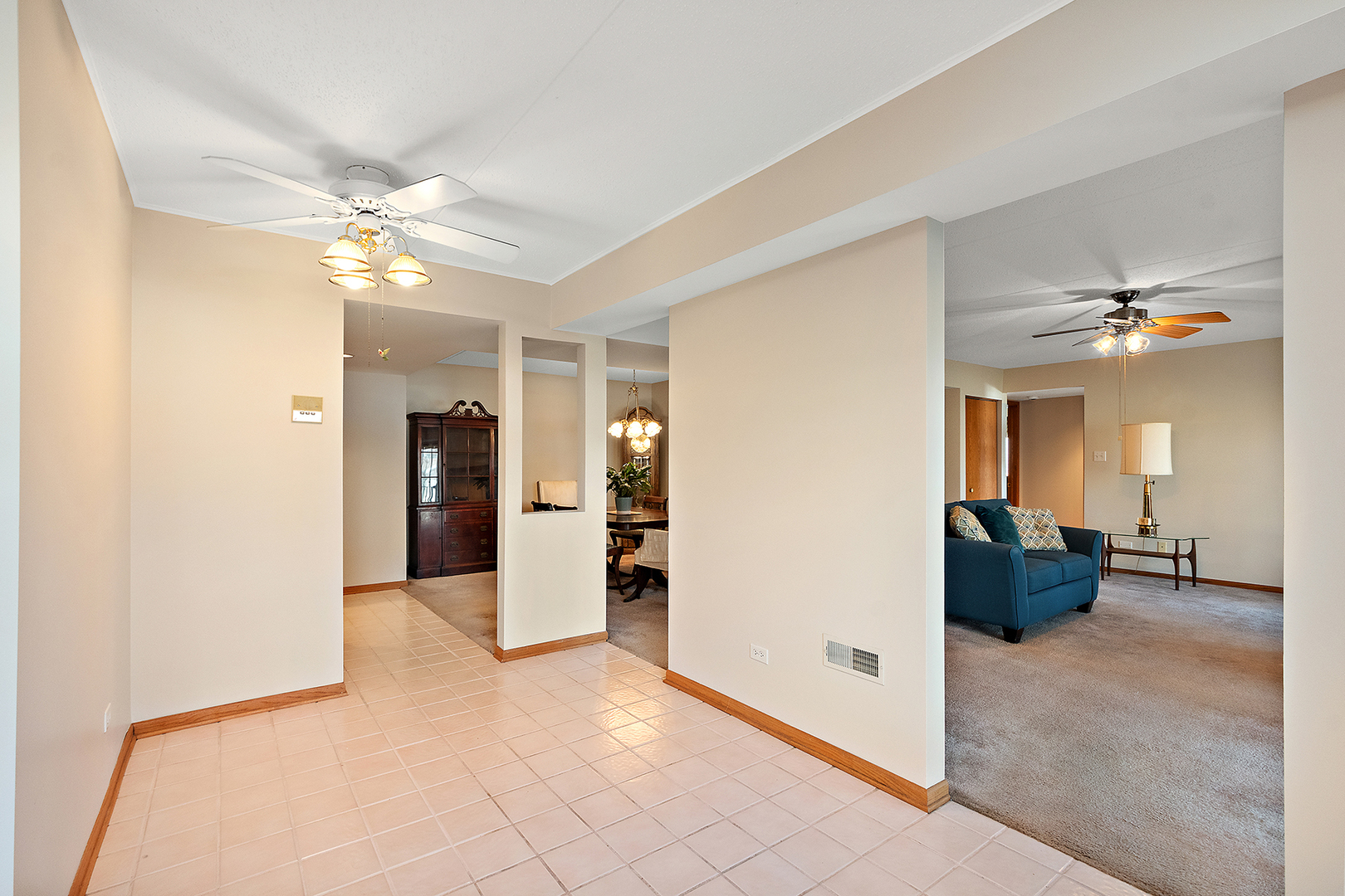 18136 Rita Road, Unit 1C Tinley Park, IL 60477 - Photo 4 of 26 a view of a livingroom and a chandelier fan and windows