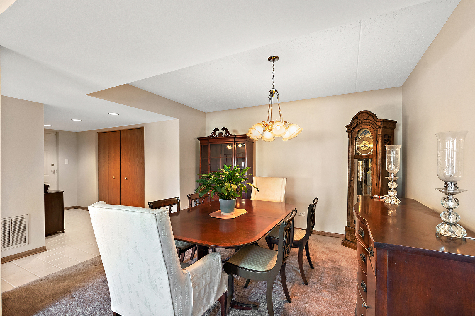 18136 Rita Road, Unit 1C Tinley Park, IL 60477 - Photo 6 of 26 a view of a dining room with furniture and chandelier