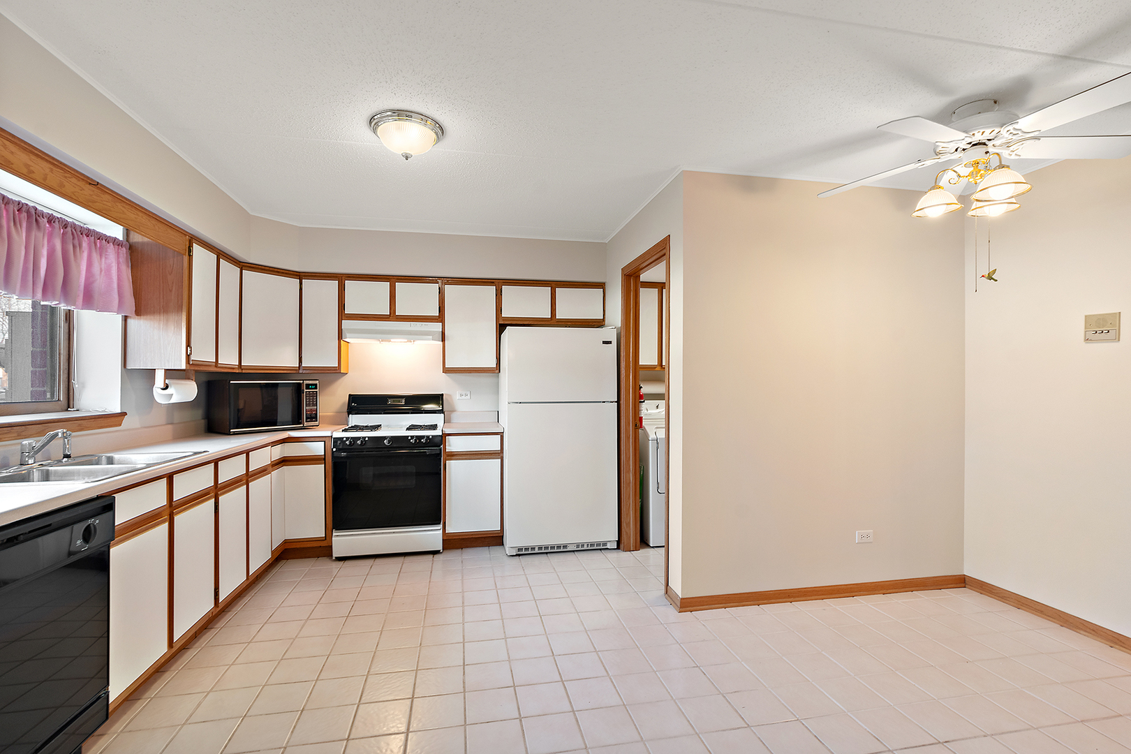 18136 Rita Road, Unit 1C Tinley Park, IL 60477 - Photo 10 of 26 a large kitchen with cabinets and stainless steel appliances