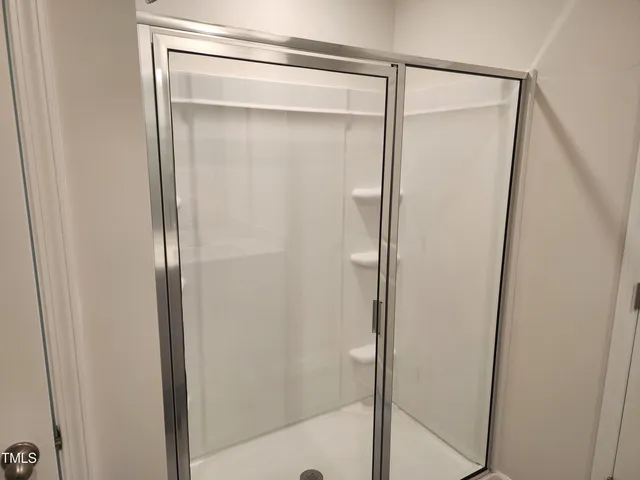 a bathroom with a glass shower door