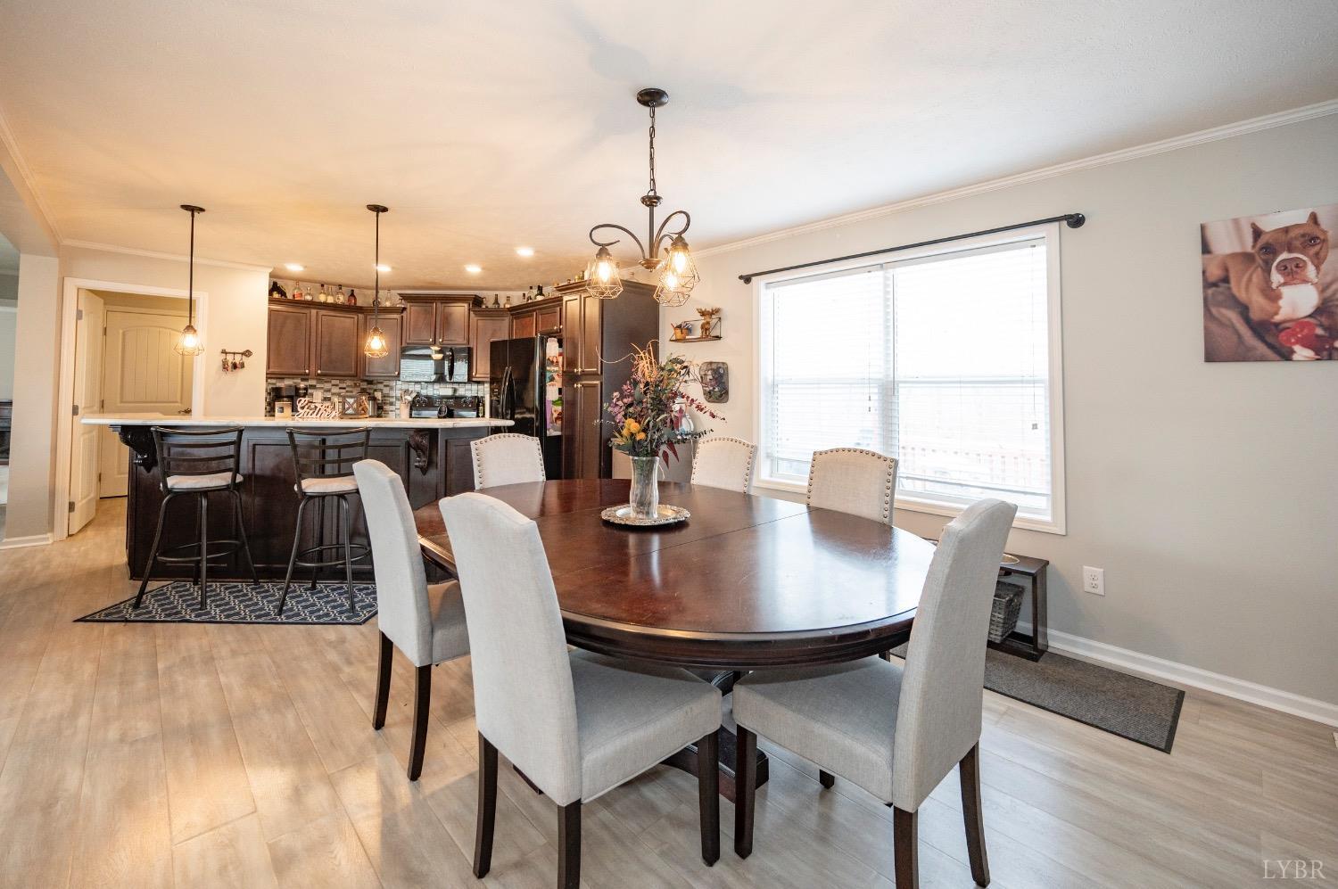 563 Evington Road Evington, VA 24550 - Photo 13 of 17 a dining room with furniture a chandelier and wooden floor