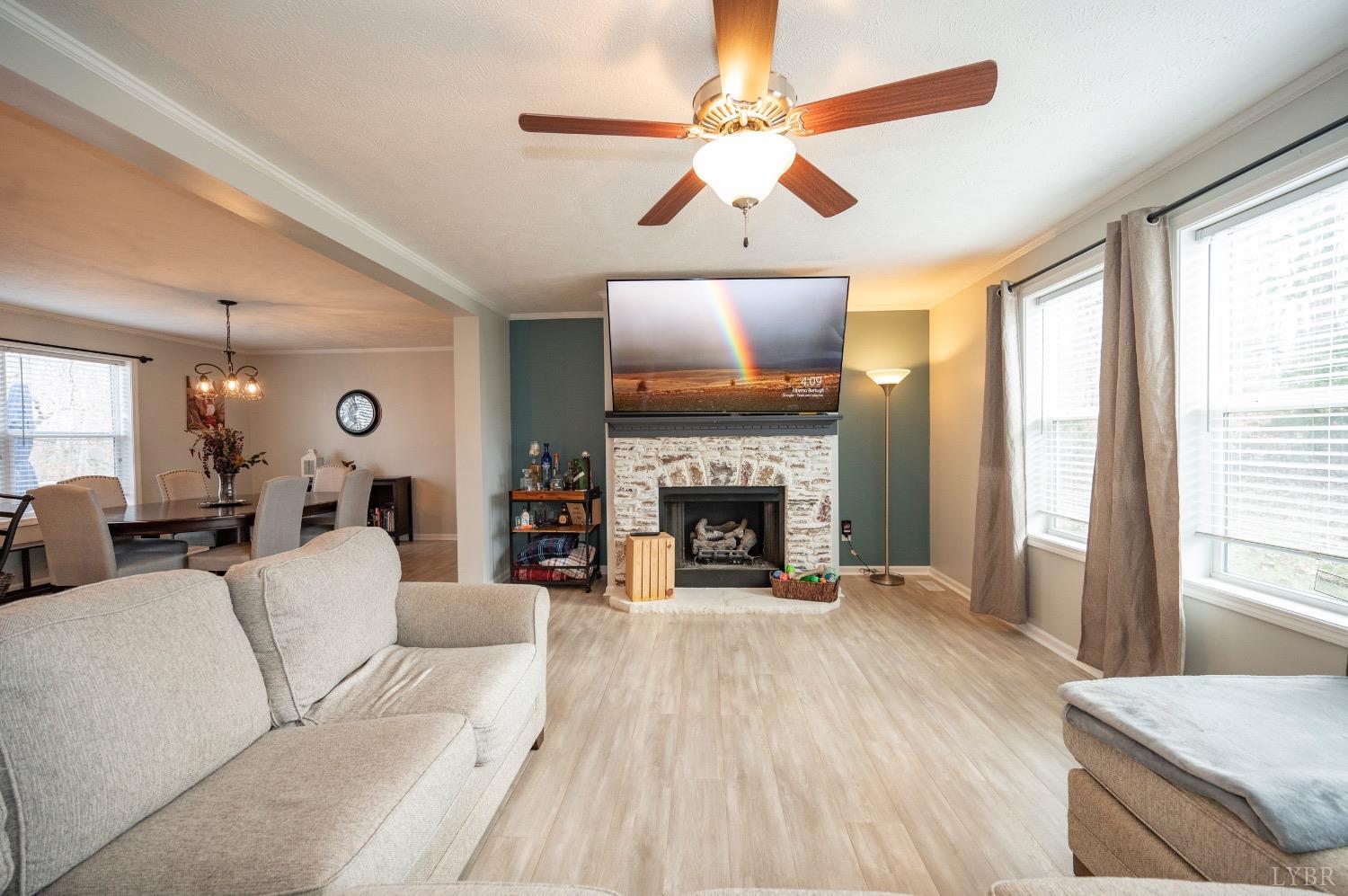 563 Evington Road Evington, VA 24550 - Photo 4 of 17 a living room with furniture a fireplace and a flat screen tv