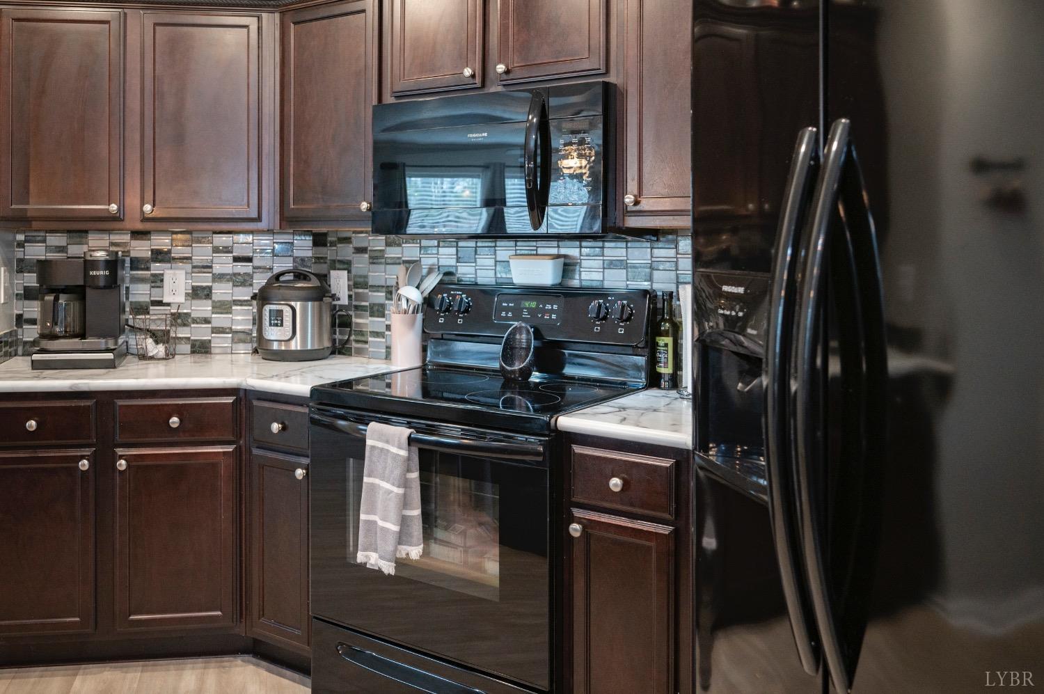 563 Evington Road Evington, VA 24550 - Photo 7 of 17 a kitchen with stainless steel appliances granite countertop a stove a refrigerator and cabinets