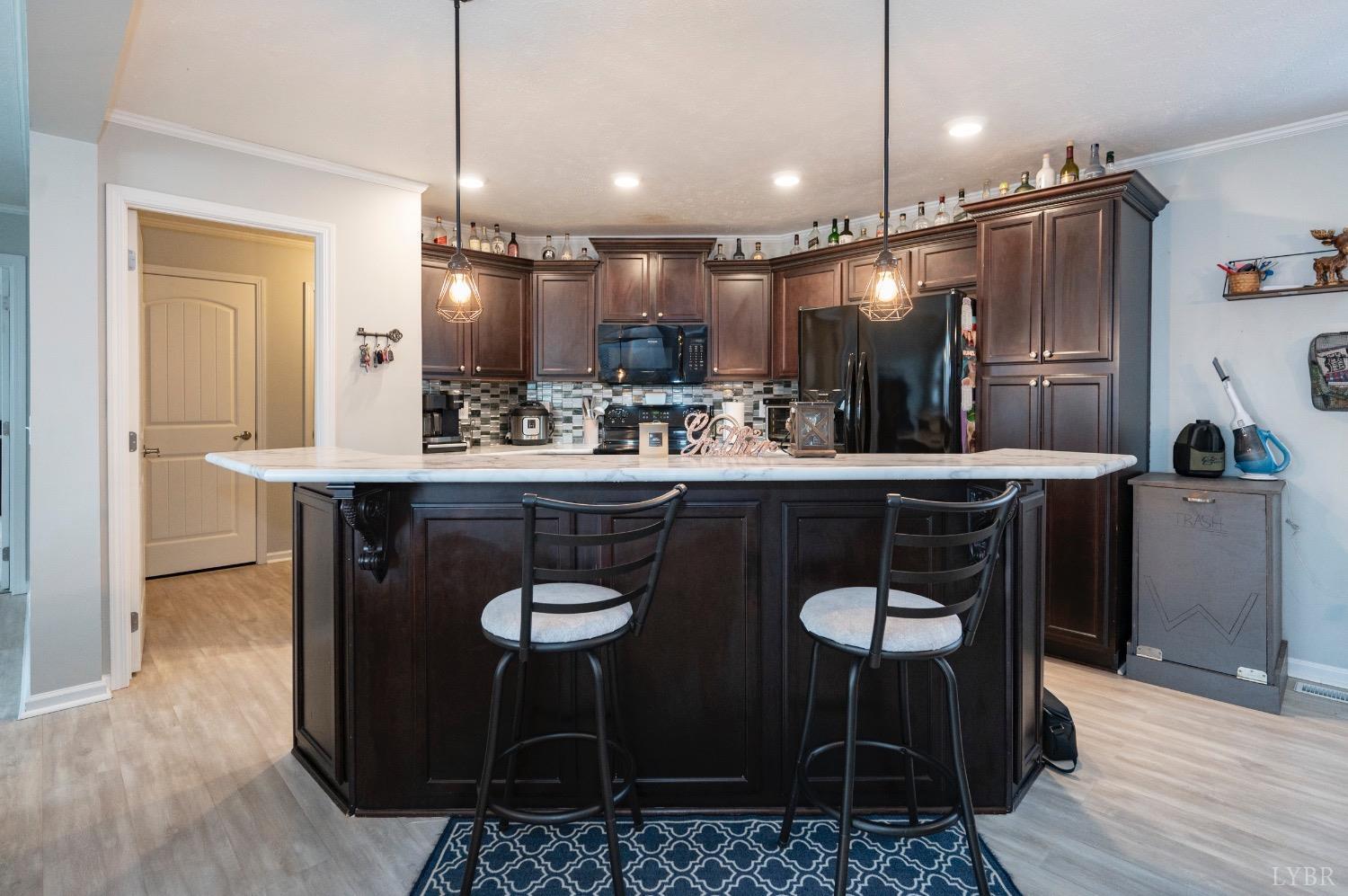 563 Evington Road Evington, VA 24550 - Photo 9 of 17 a kitchen with a table chairs and a refrigerator
