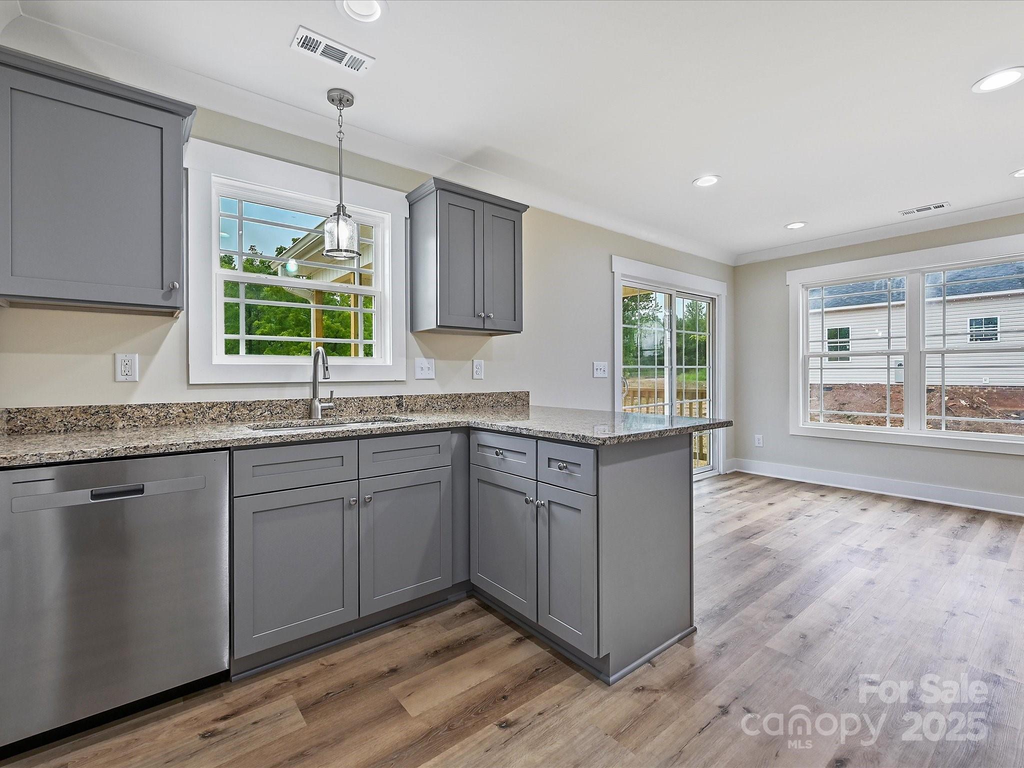 254 Old Pinckney Road York, SC 29745 - Photo 11 of 26 a kitchen with granite countertop wooden cabinets a sink and a window