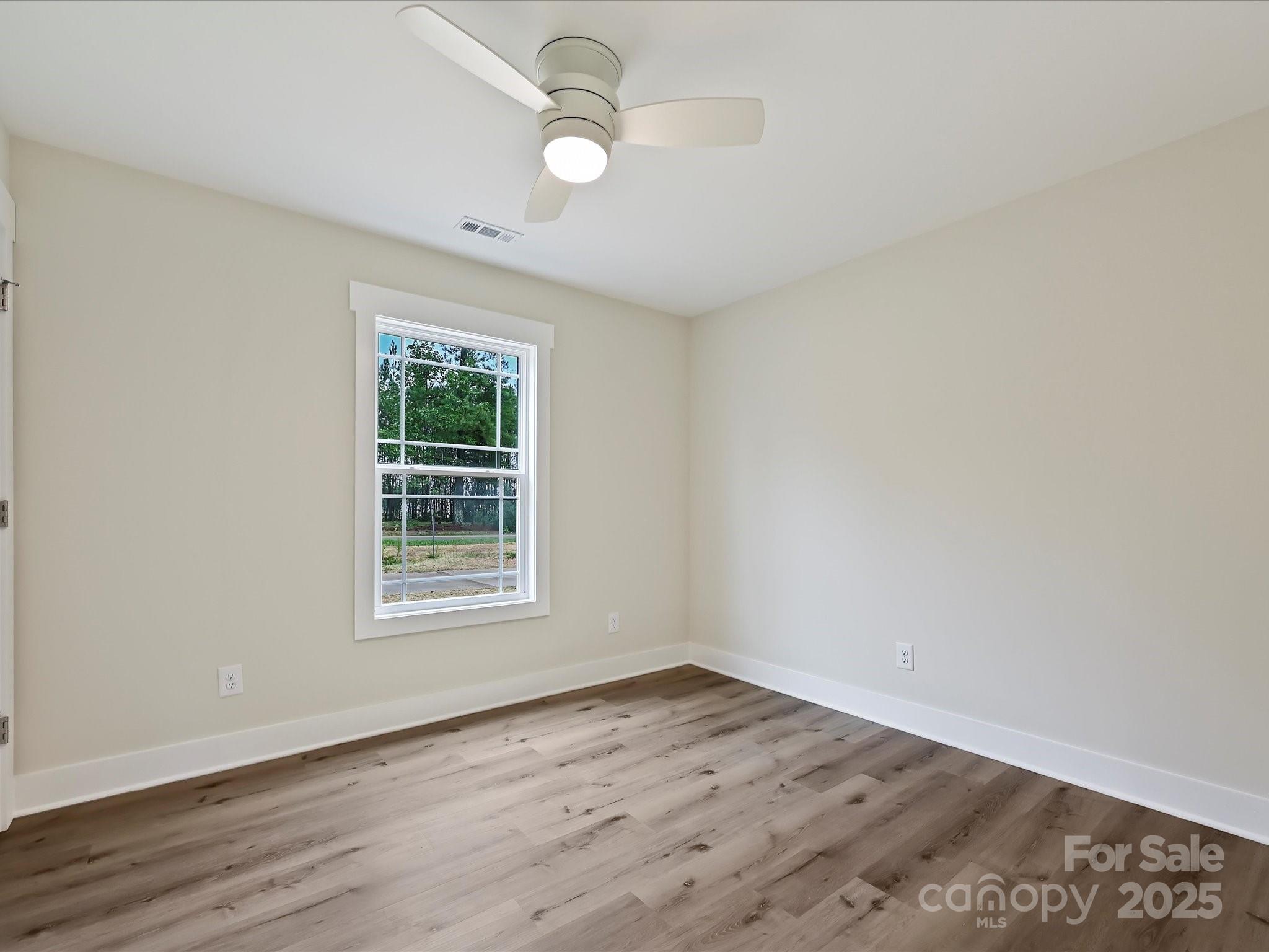 254 Old Pinckney Road York, SC 29745 - Photo 19 of 26 an empty room with wooden floor and windows