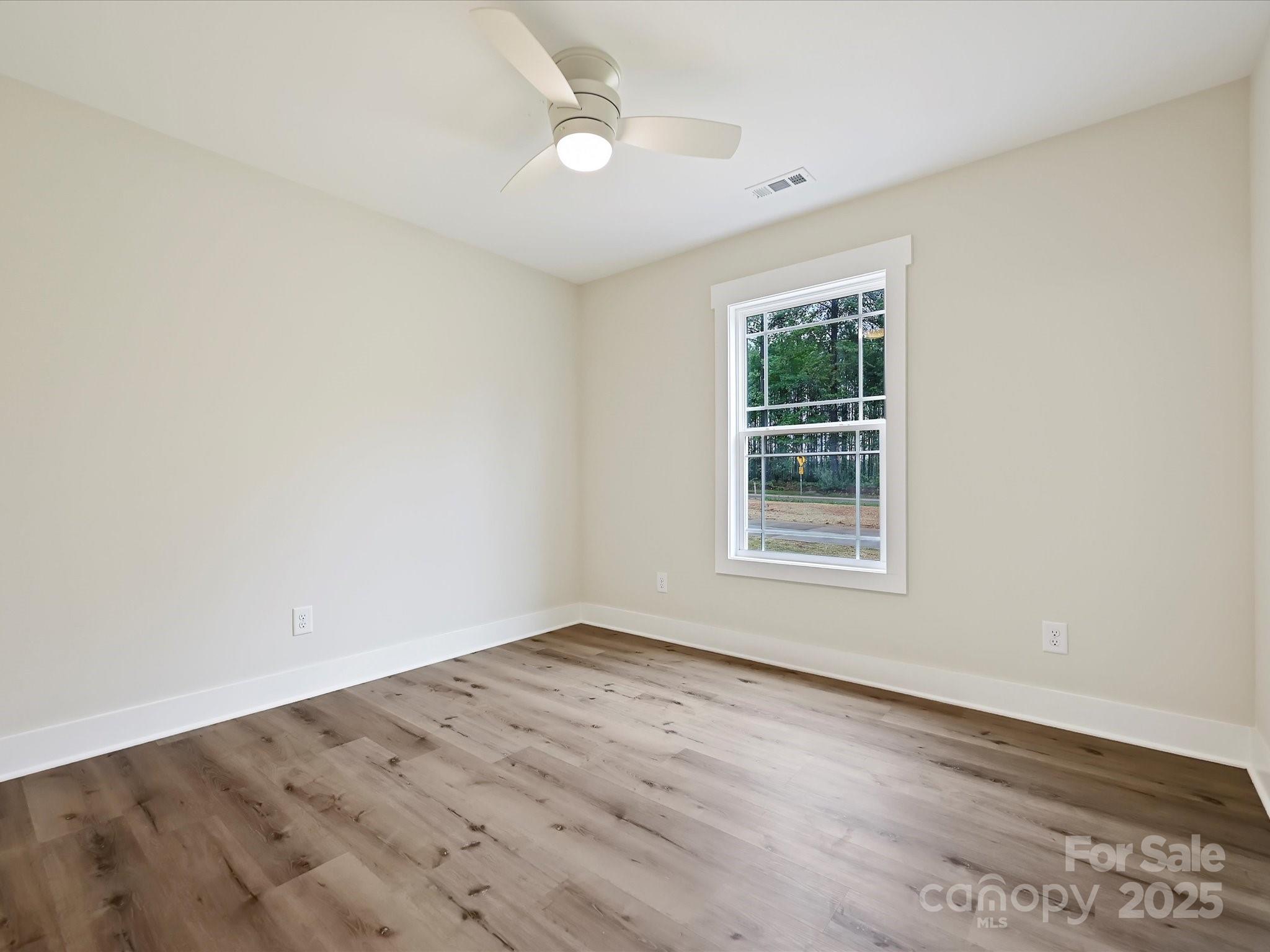 254 Old Pinckney Road York, SC 29745 - Photo 21 of 26 a view of an empty room with wooden floor and a window