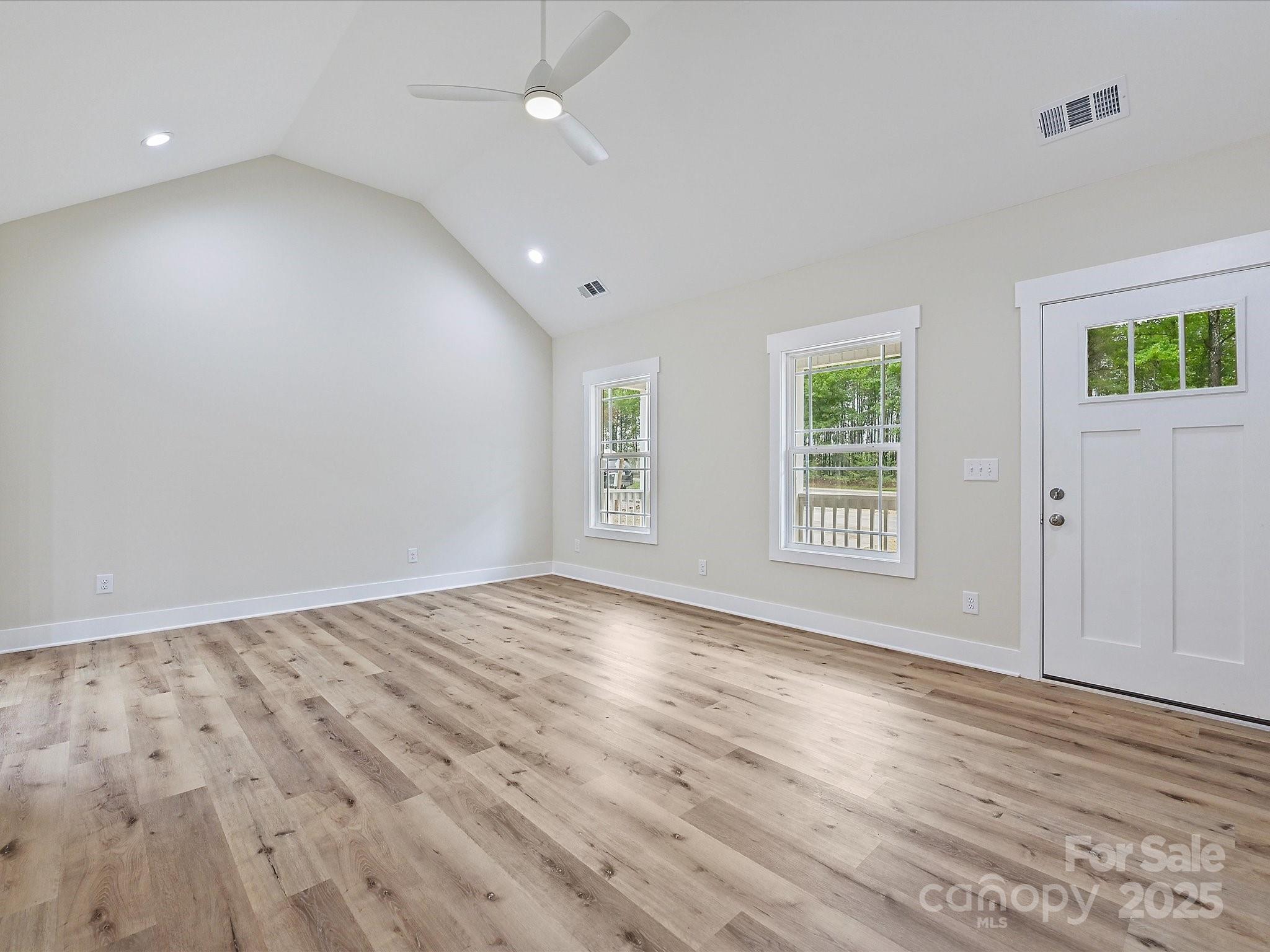 254 Old Pinckney Road York, SC 29745 - Photo 3 of 26 an empty room with wooden floor and windows