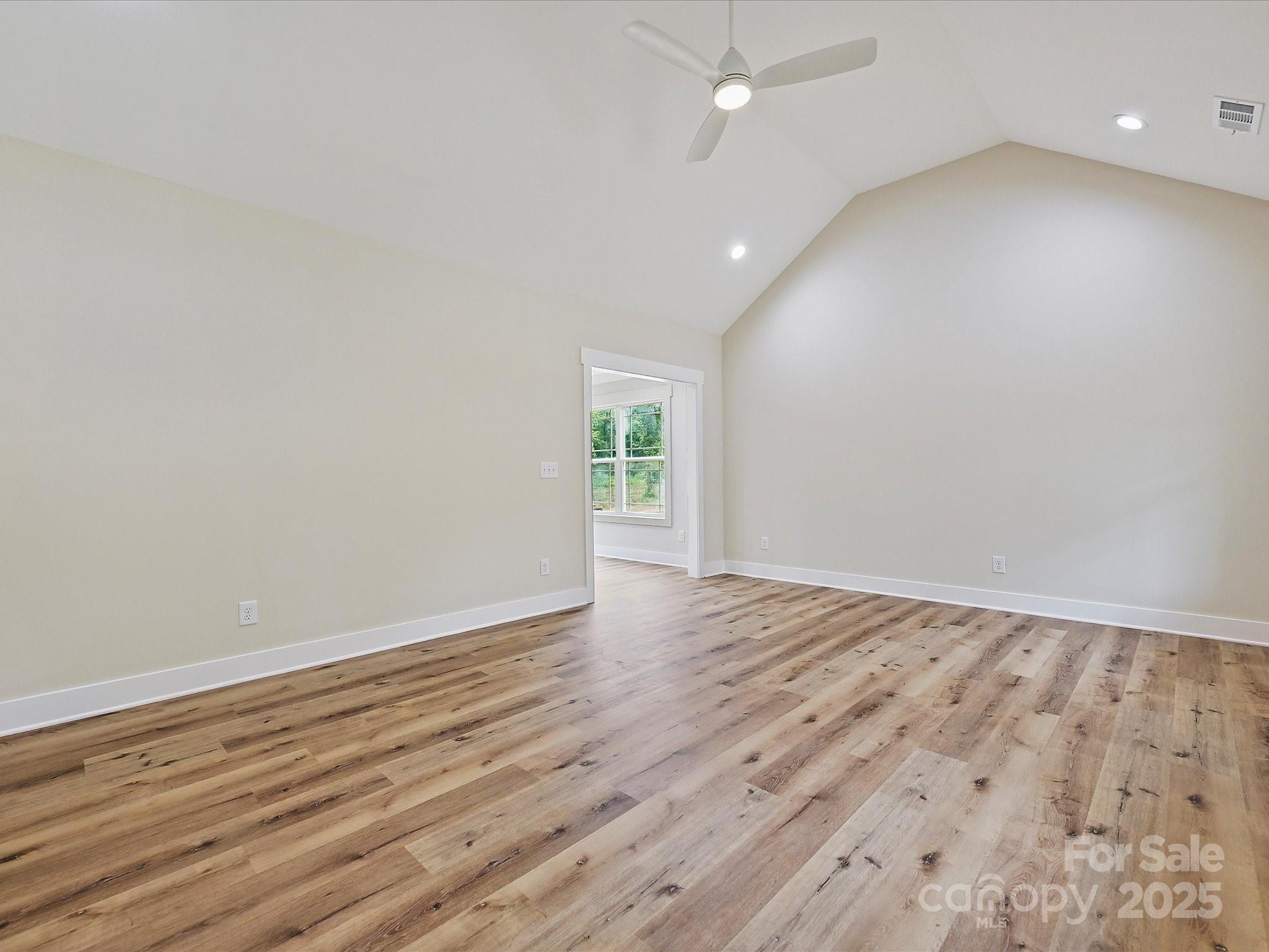 254 Old Pinckney Road York, SC 29745 - Photo 4 of 26 an empty room with wooden floor and windows