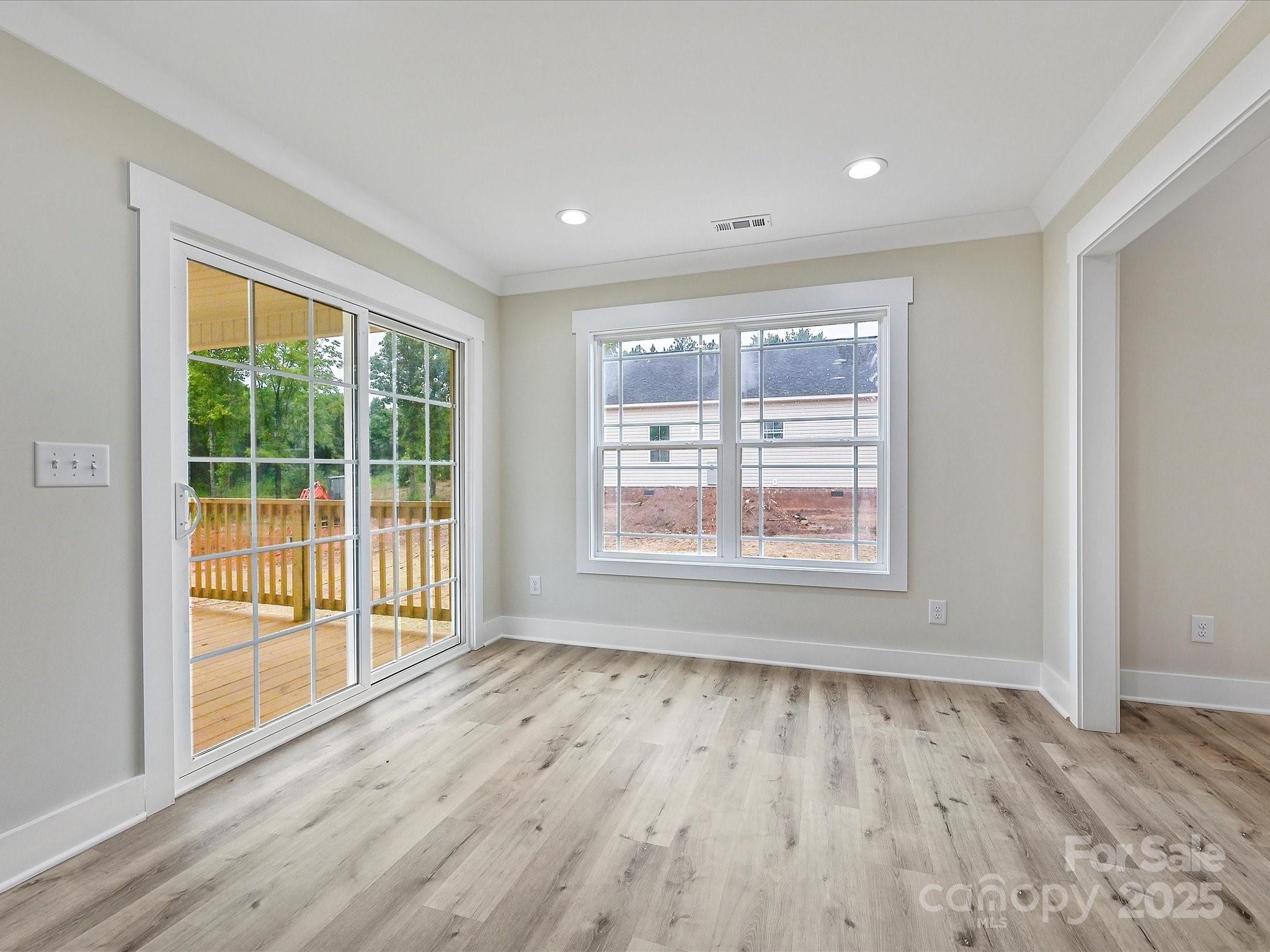 254 Old Pinckney Road York, SC 29745 - Photo 6 of 26 a view of an empty room with wooden floor and a window