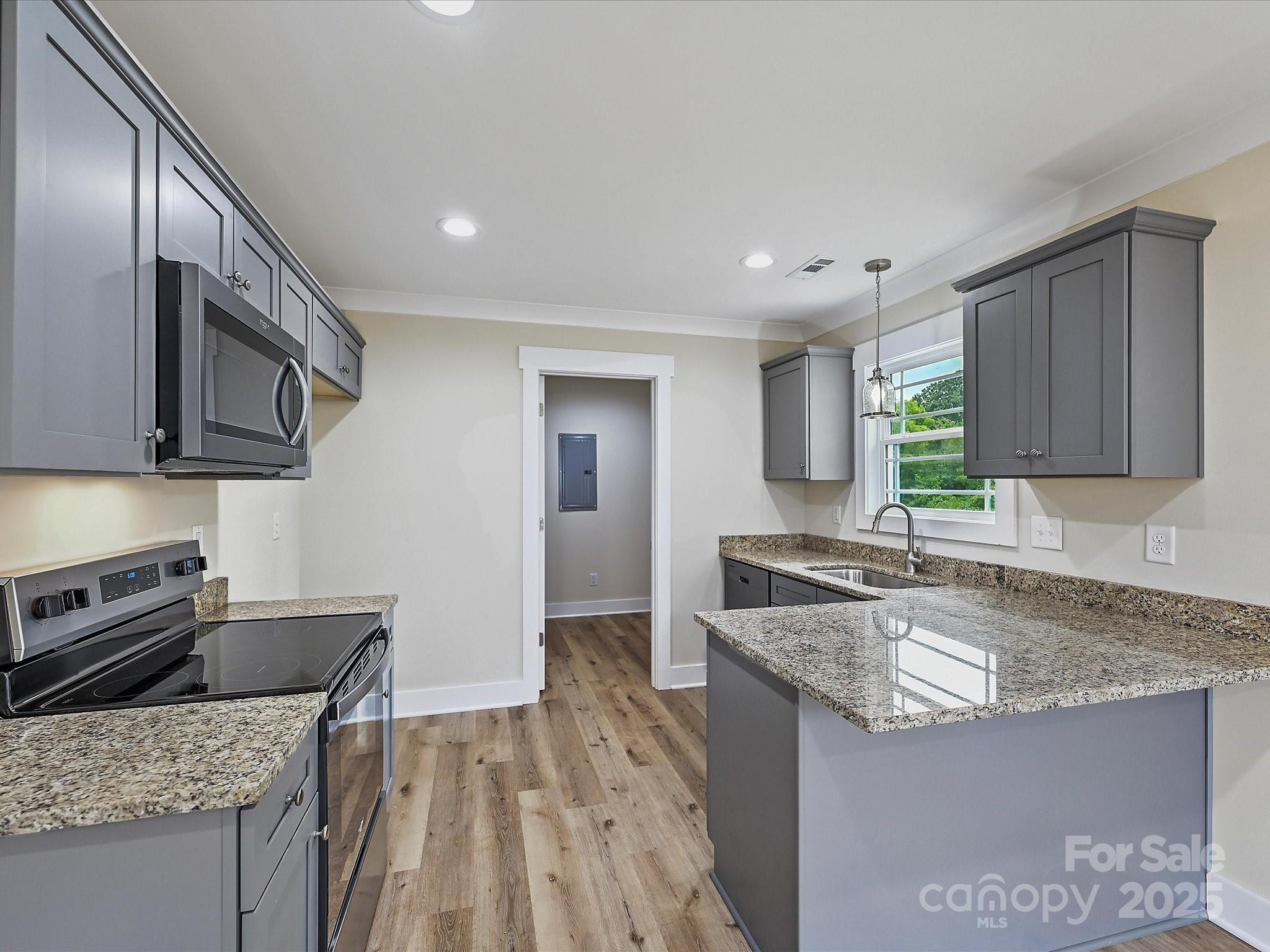 254 Old Pinckney Road York, SC 29745 - Photo 8 of 26 a kitchen with stainless steel appliances granite countertop a sink stove and microwave