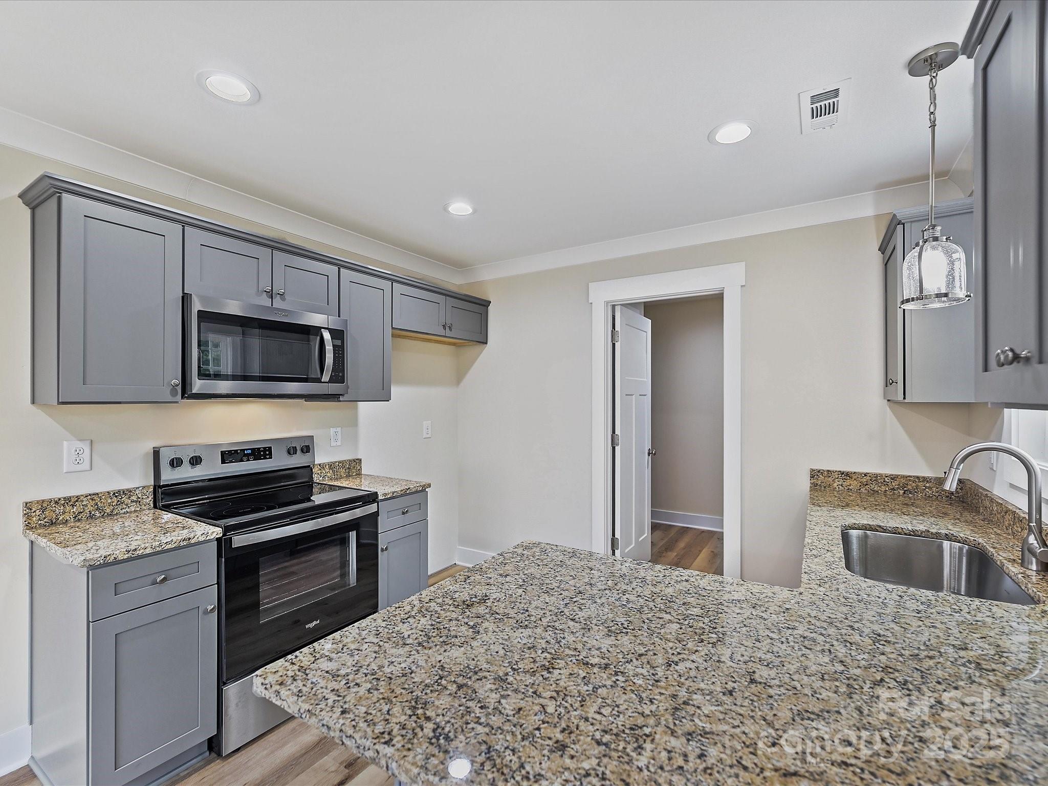 254 Old Pinckney Road York, SC 29745 - Photo 9 of 26 a kitchen with granite countertop a sink stainless steel appliances and cabinets