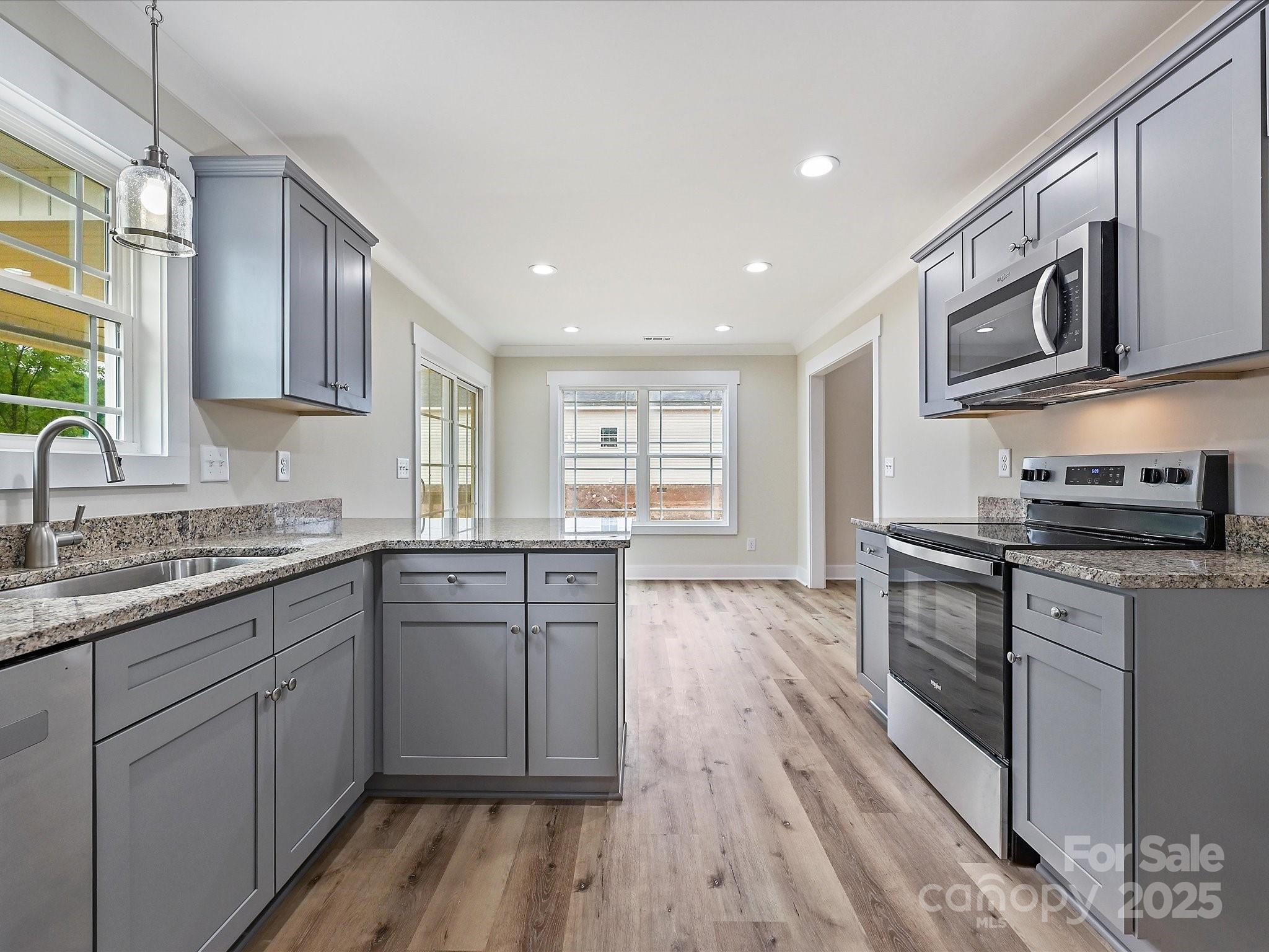 254 Old Pinckney Road York, SC 29745 - Photo 10 of 26 a kitchen with stainless steel appliances granite countertop wooden cabinets and a stove top oven