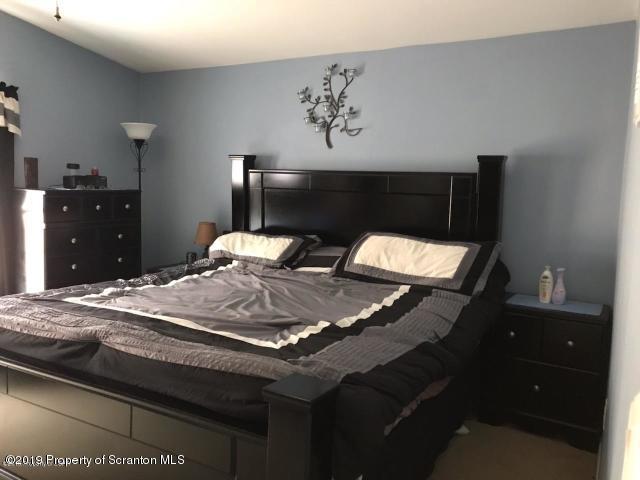 563 Maple Grove Road Moscow, PA 18444 - Photo 17 of 20 a bedroom with a bed and dresser