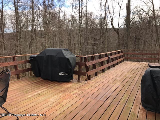 563 Maple Grove Road Moscow, PA 18444 - Photo 2 of 20 a view of a roof deck with wooden floor and fence
