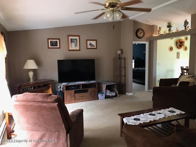 563 Maple Grove Road Moscow, PA 18444 - Photo 8 of 20 a living room with furniture and a flat screen tv